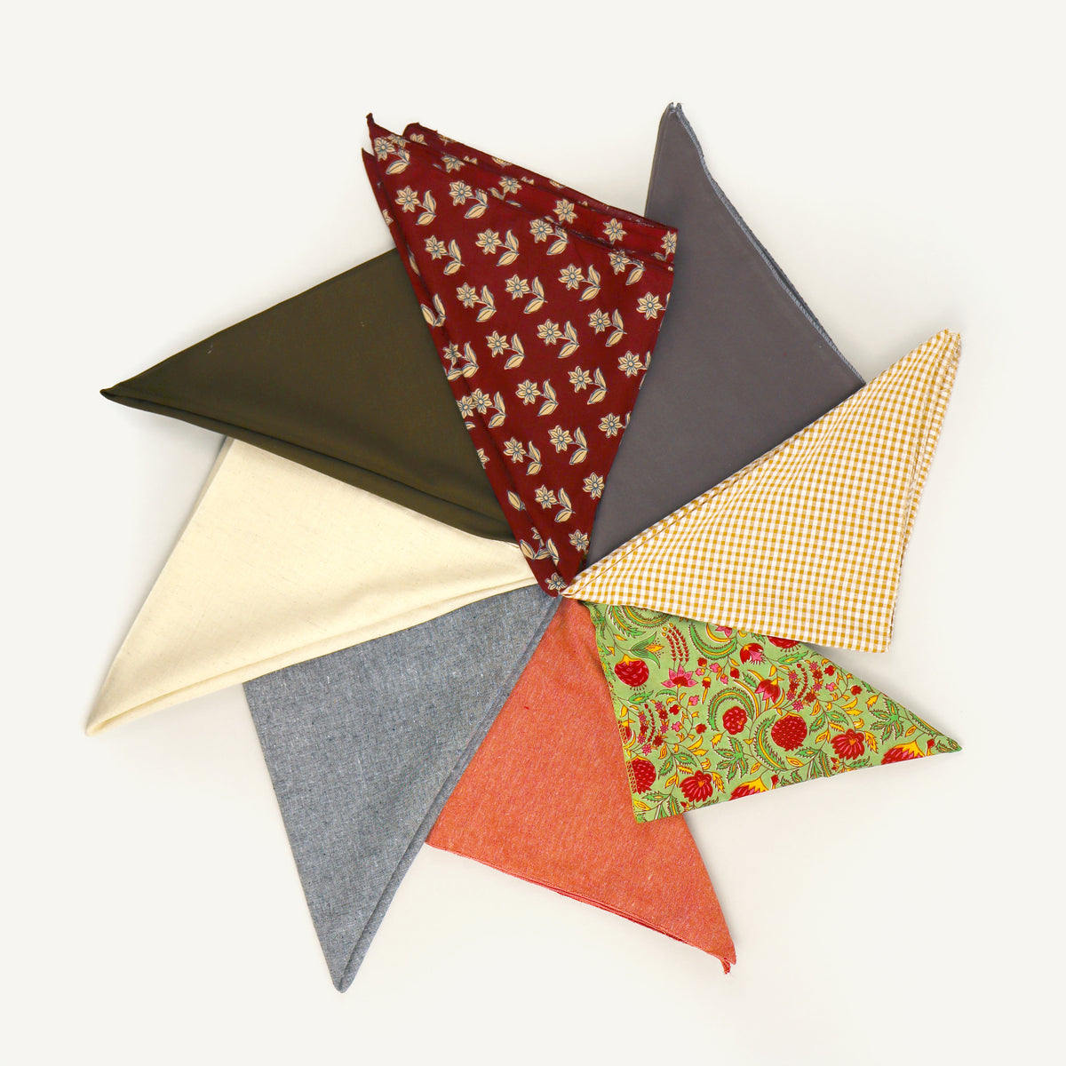 Collection of colorful fabric triangles on a white background