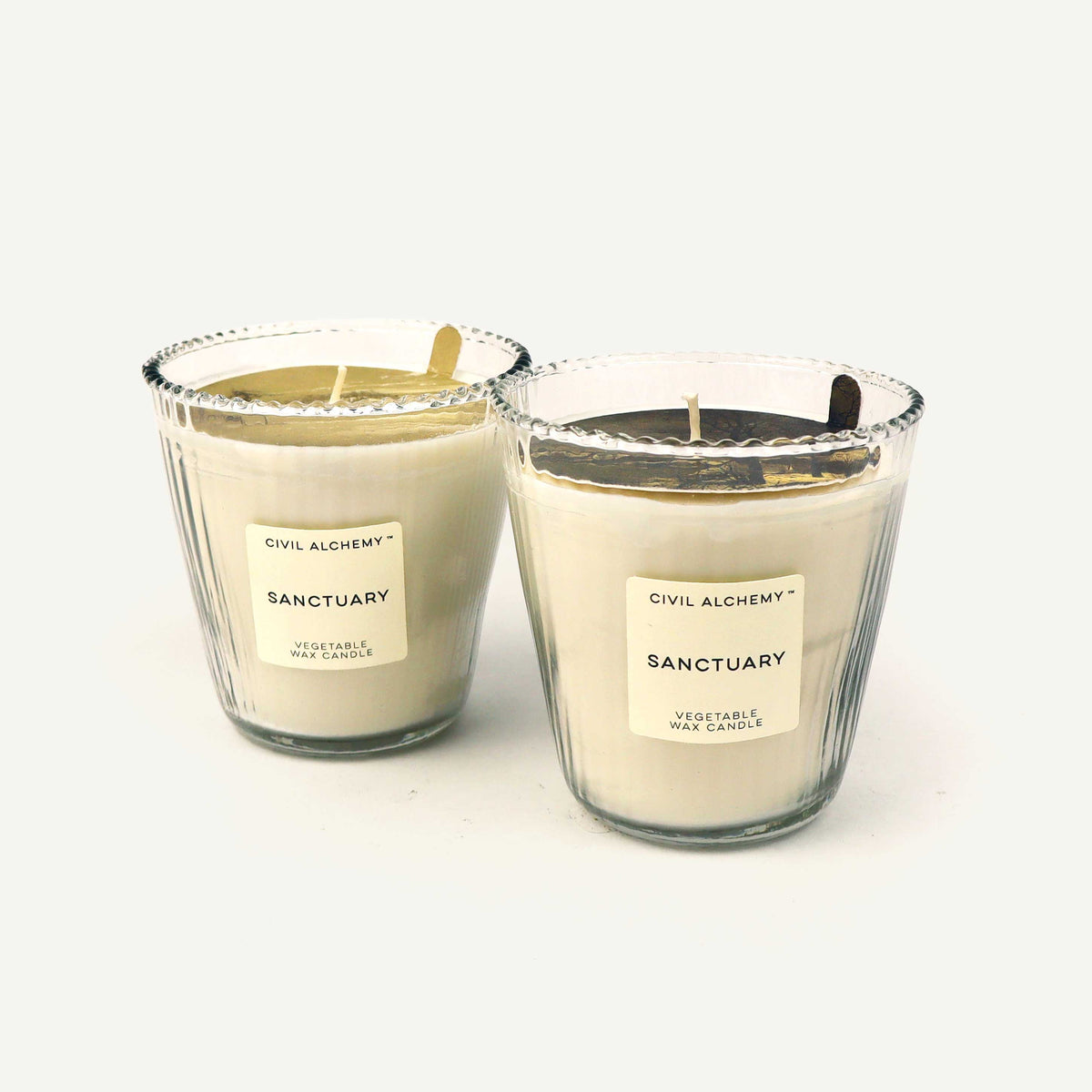 Two candles labeled 'Sanctuary' by Civil Alchemy on a white background