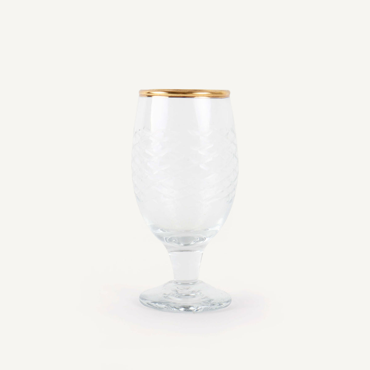 Clear glass with gold rim on a white background
