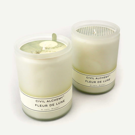 Two candles from Civil Alchemy on a white background