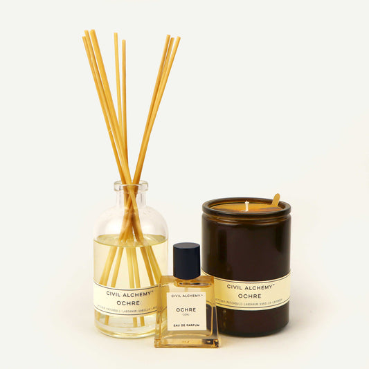Set of diffuser sticks, bottle, and candle with 'Civil Alchemy' branding on a white background