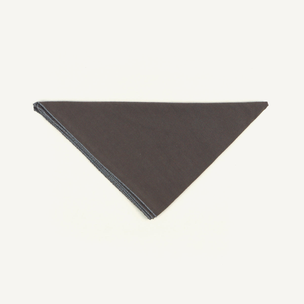 Dark gray triangular fabric sample on a white background