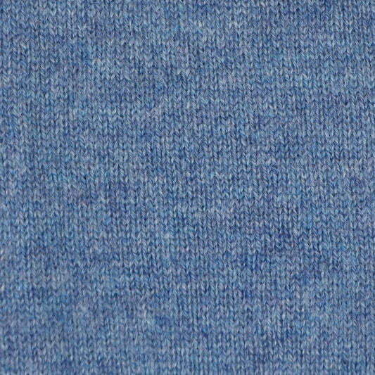 A close-up of a blue knit fabric texture, showing the detailed ribbed pattern and heathered weave.