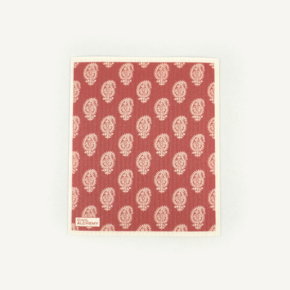 Red Swedish dishcloth with white floral pattern on a white background