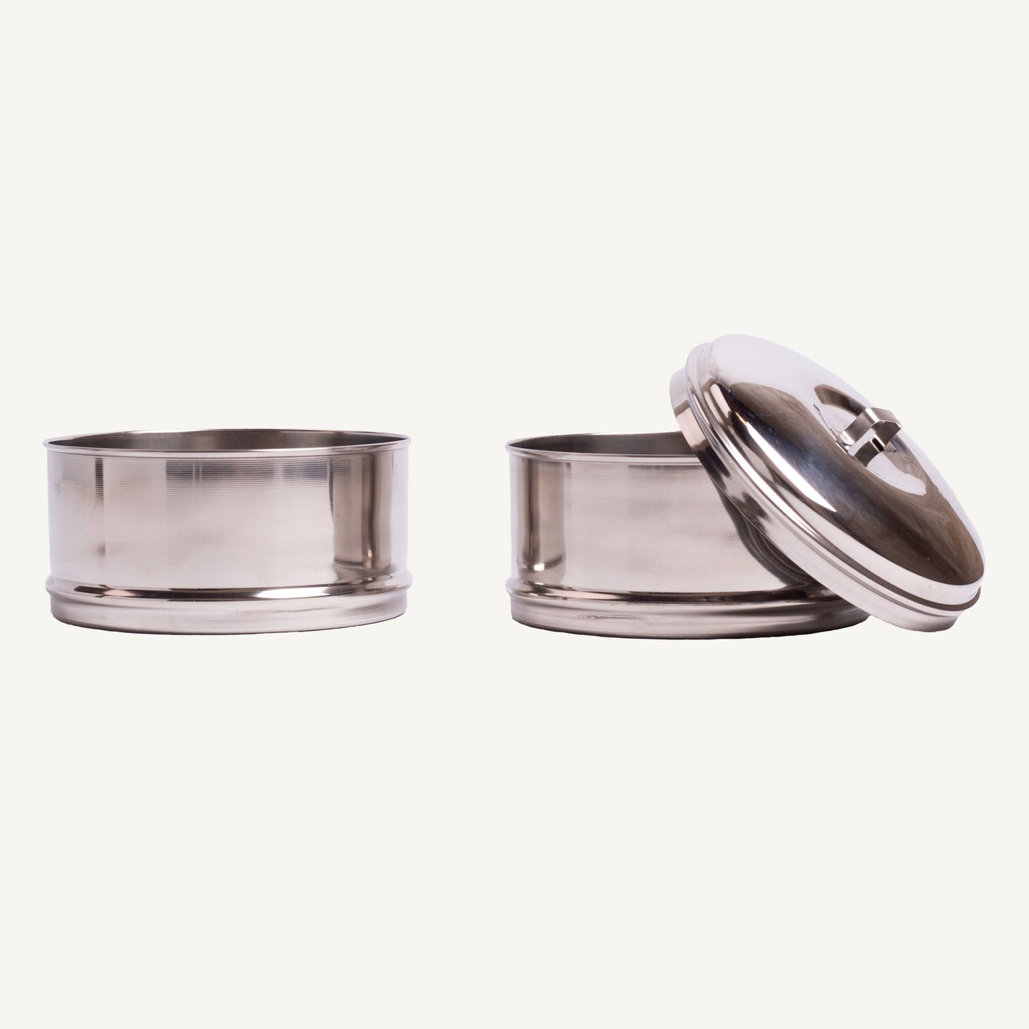 Two stainless steel containers with lids on a white background