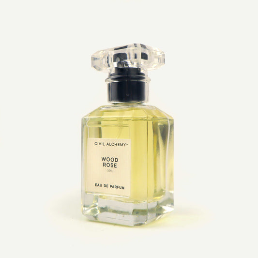 Perfume bottle labeled 'Wood Rose' by Civil Alchemy on a white background