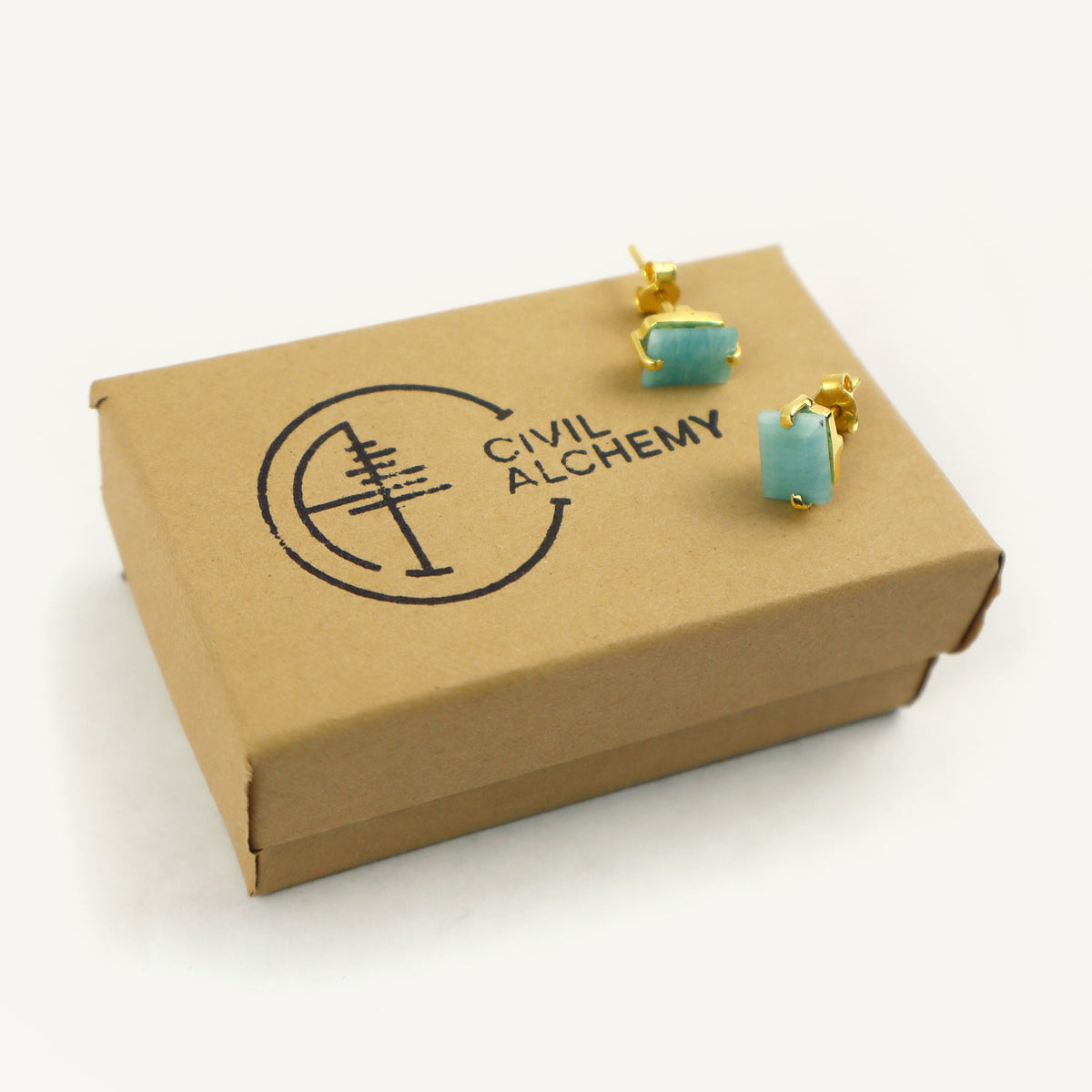 Turquoise earrings on a 'Civil Alchemy' branded box