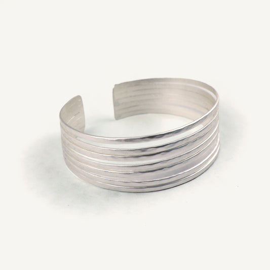 Silver cuff bracelet on a white background