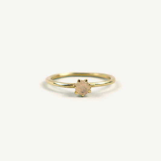 Gold ring with a small gemstone on a white background
