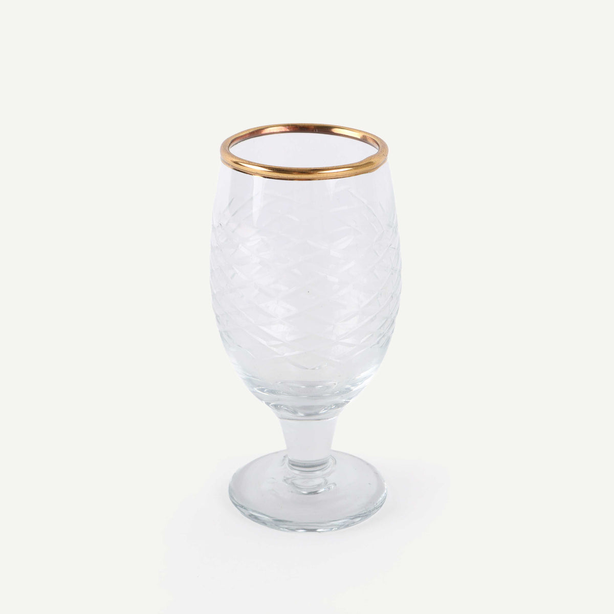 Clear glass with gold rim on a white background
