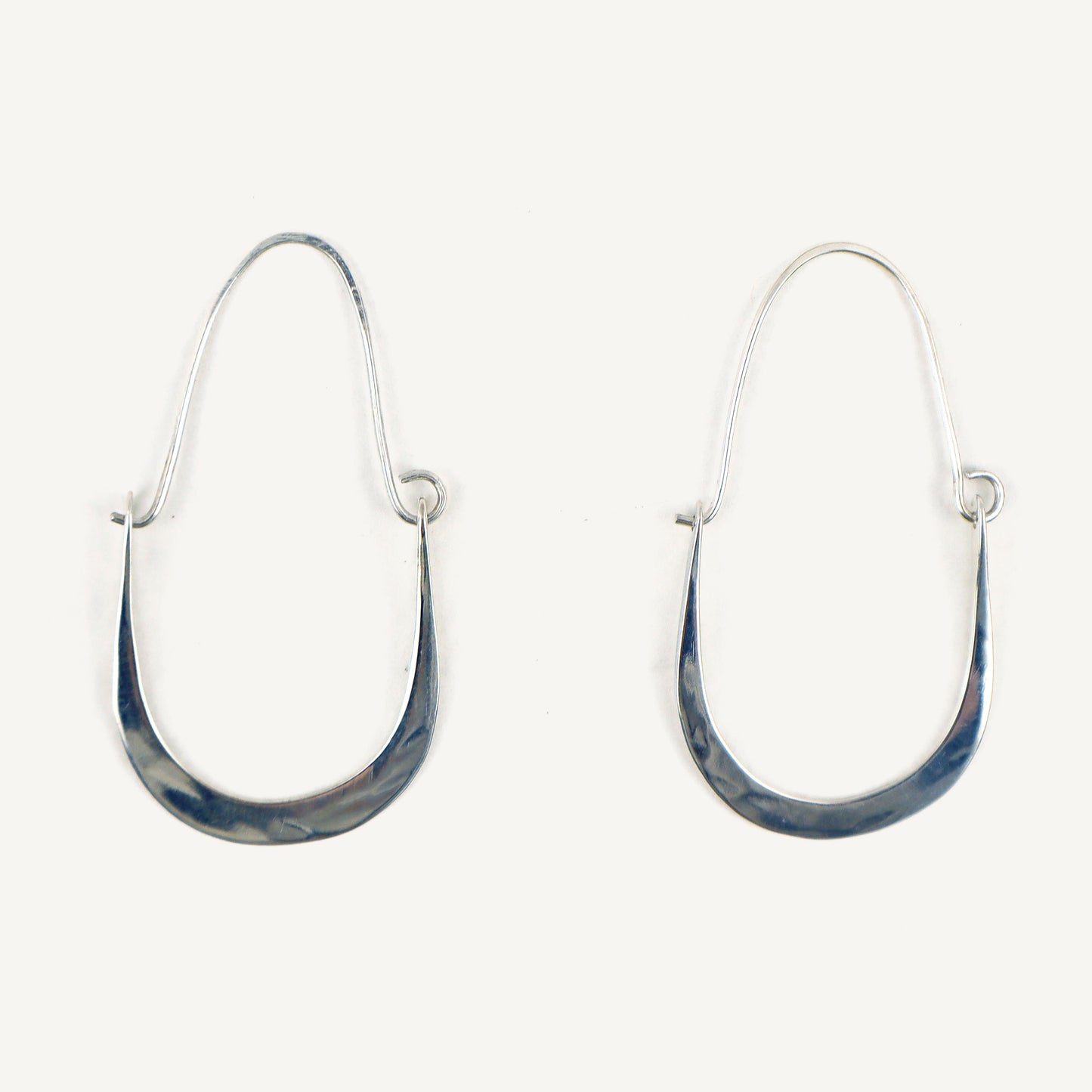 Pair of silver hoop earrings with blue marbled finish on a white background