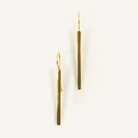 Pair of gold earrings on a white background