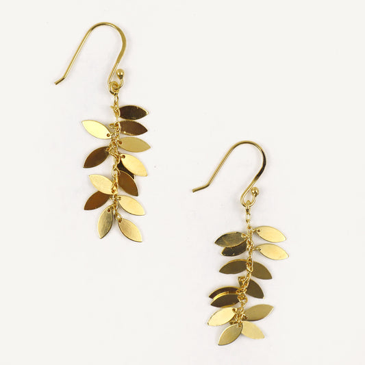 Gold leaf-shaped earrings on a white background