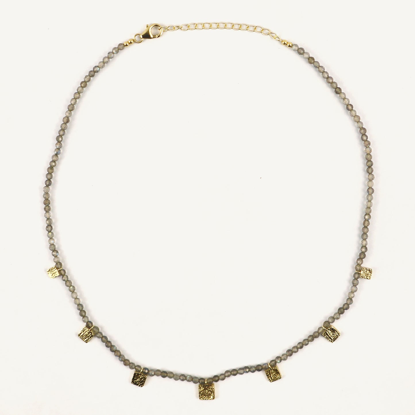 Necklace with gray beads and gold accents on a white background