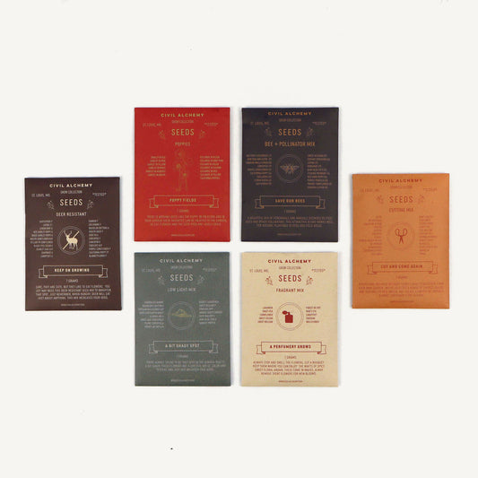 Set of six seed packets with different color schemes on a white background