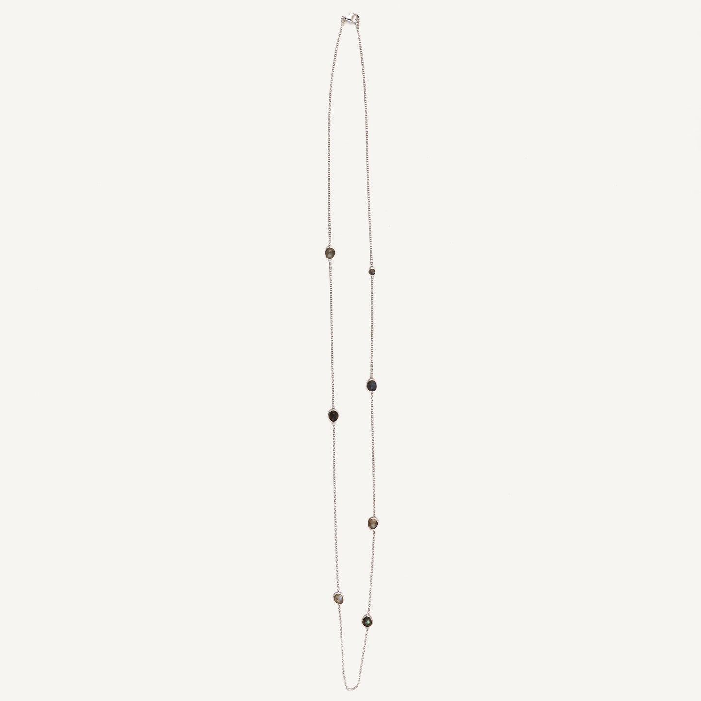 Long necklace with small beads on a white background