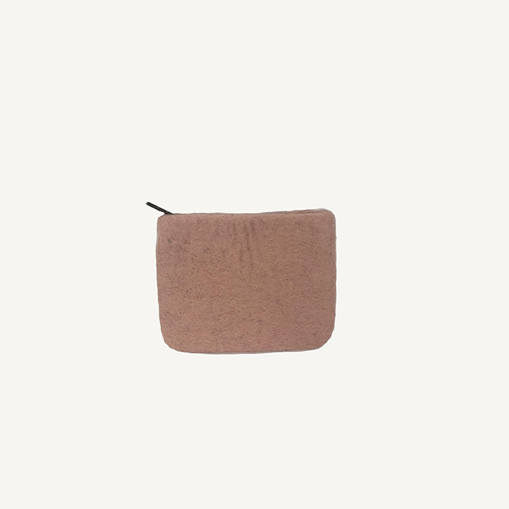A solid black wool coin pouch with a brass zipper, hand-felted by artisans in Nepal.
