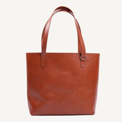 Brown leather tote bag on a white background