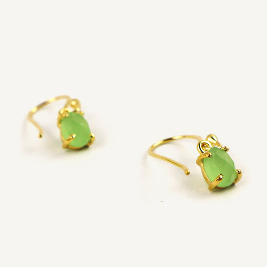 Gold earrings with green teardrop-shaped stones on a white background