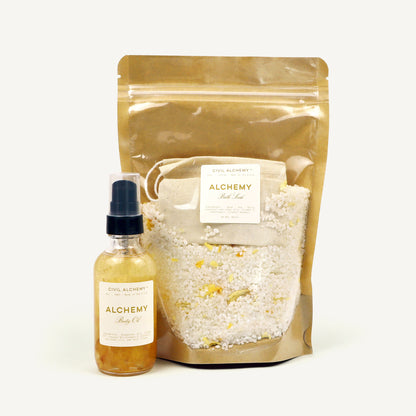 Alchemy bath oil bottle and bag with bath salts on a white background