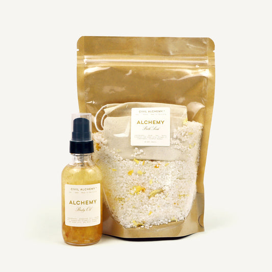Alchemy bath oil bottle and bag with bath salts on a white background
