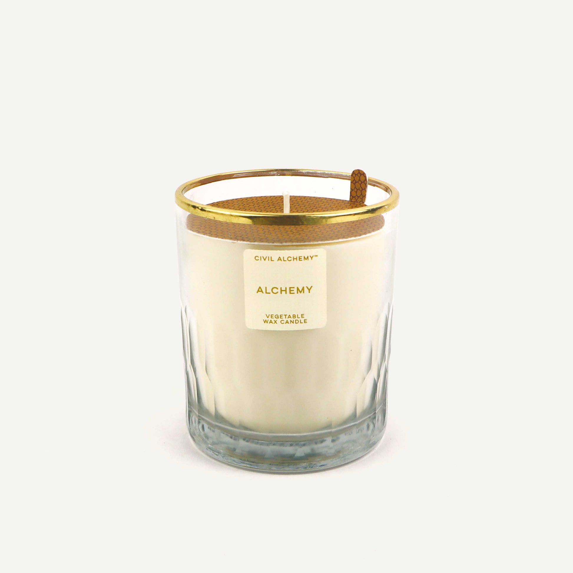 Candle with gold lid and label on a white background