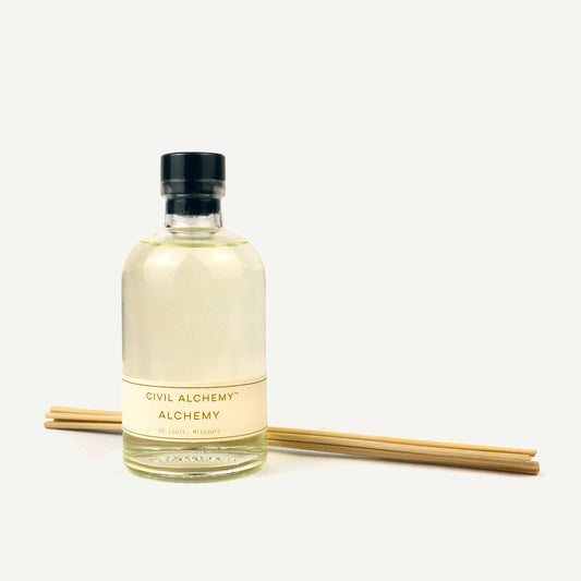 Bottle of Civil Alchemy diffuser with wooden sticks on a white background