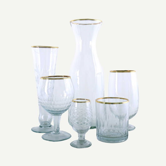 Set of glassware with gold rims on a white background