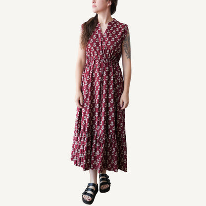 Woman wearing a red floral dress on a white background