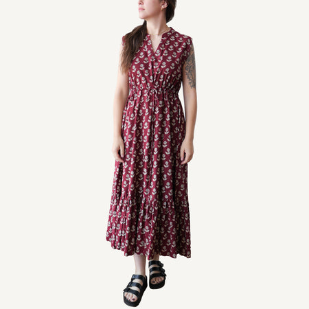 Woman wearing a red floral dress on a white background