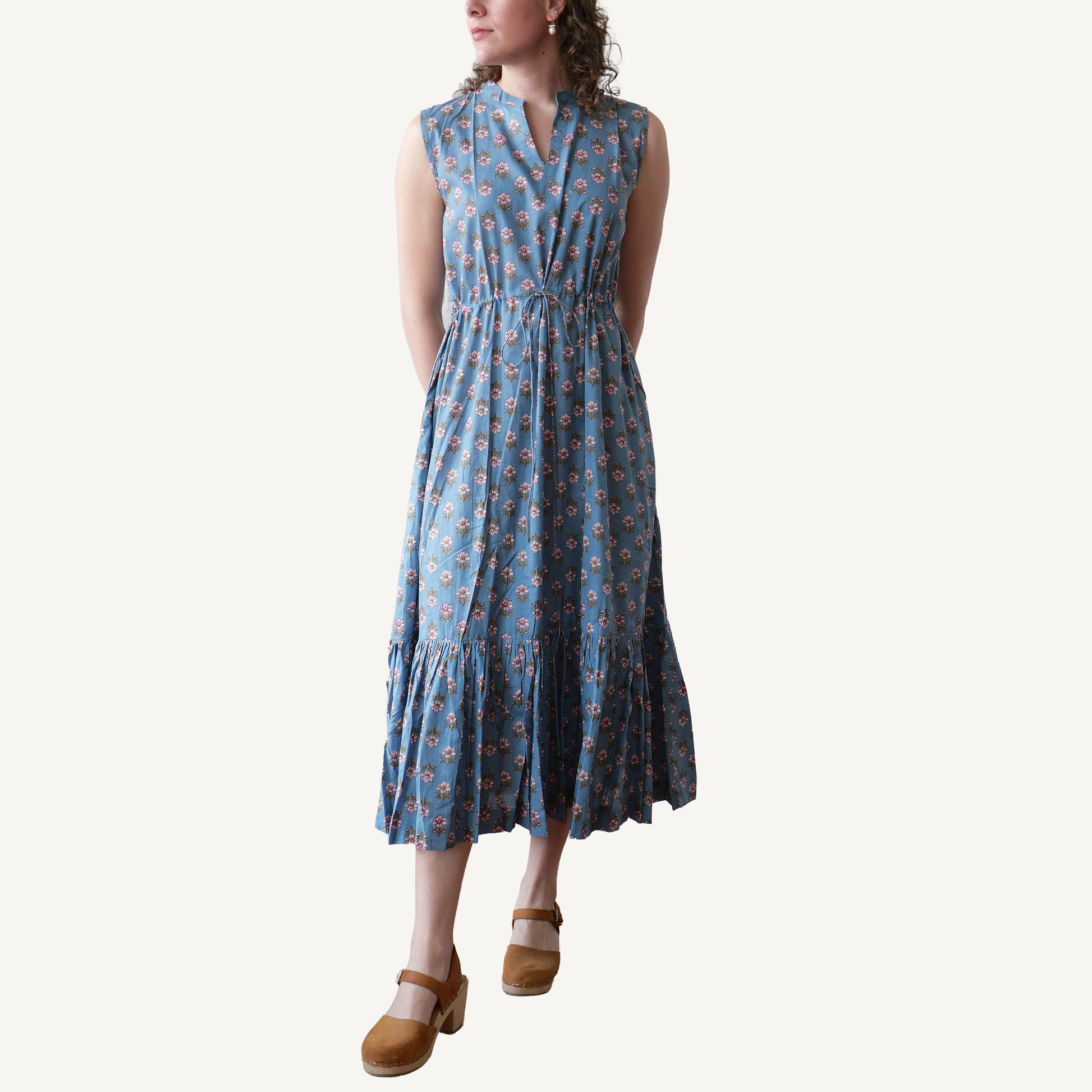 Woman wearing a blue floral dress on a white background
