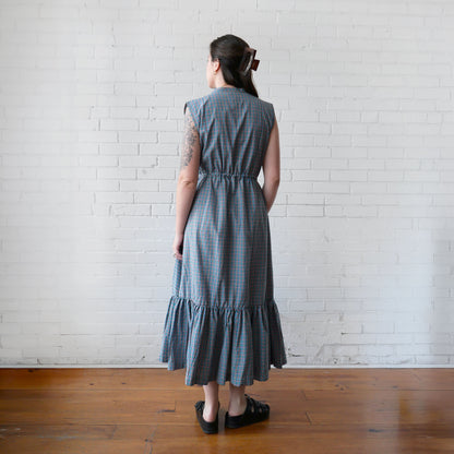 Back of dress against a white brick wall.