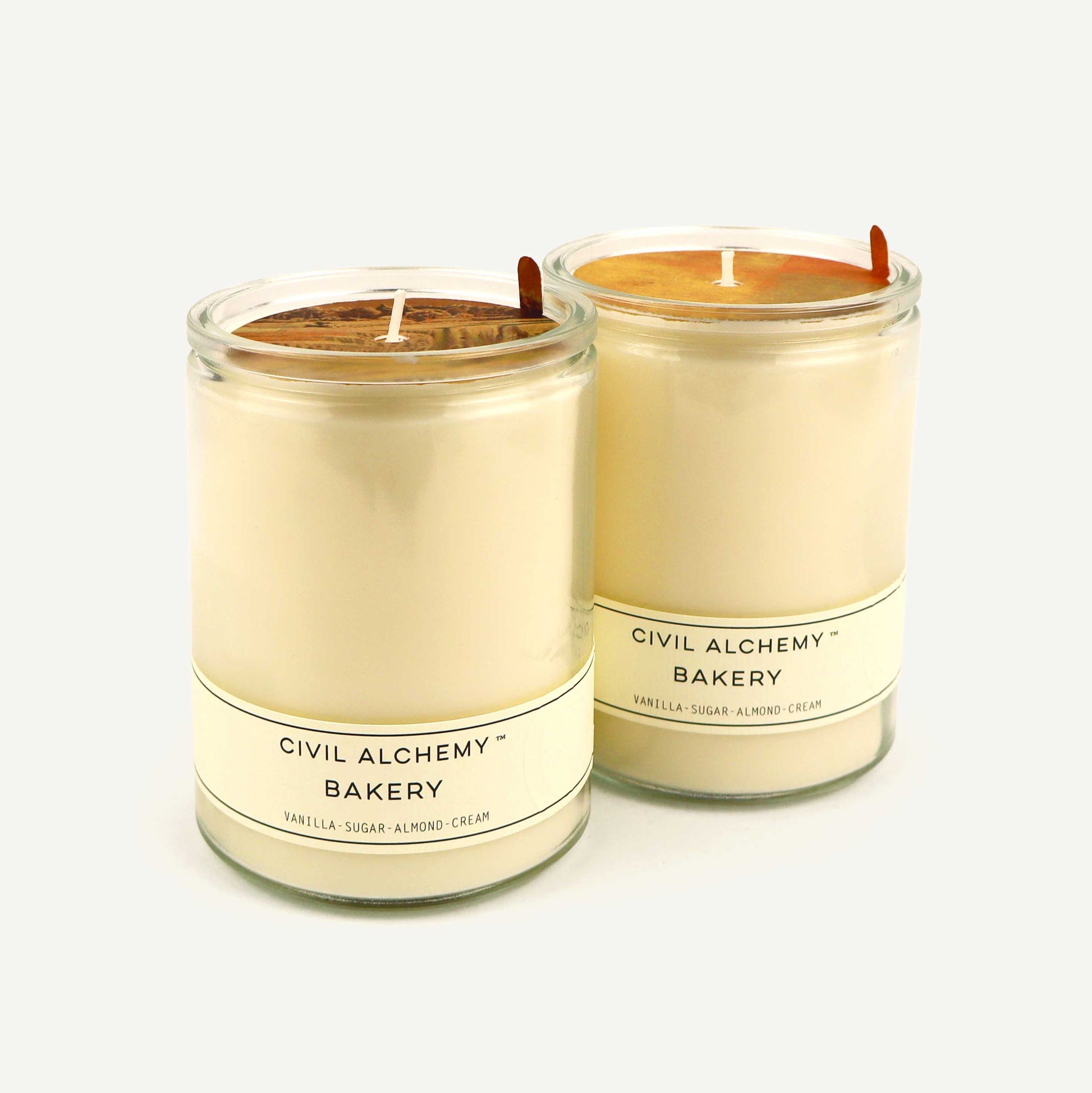 Two candles from Civil Alchemy Bakery on a white background