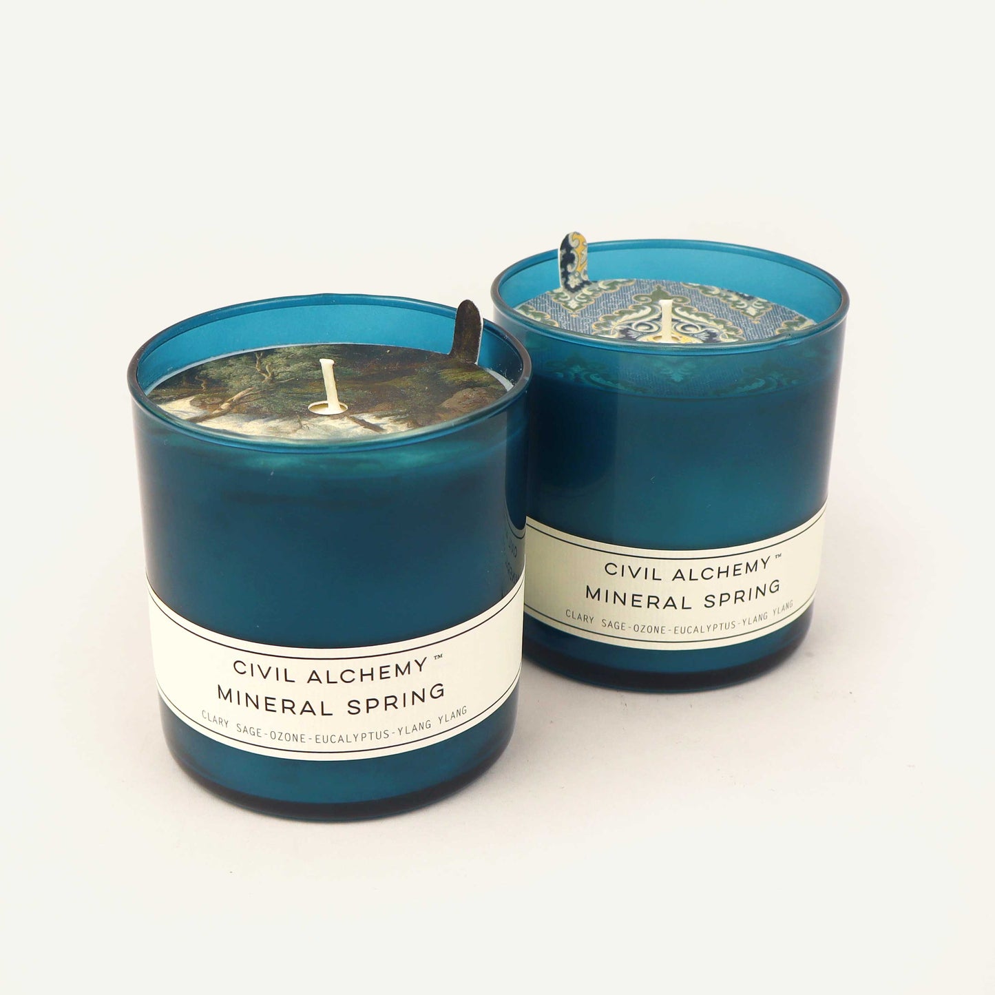 Two blue Civil Alchemy candles with "Mineral Spring" labels on a white background