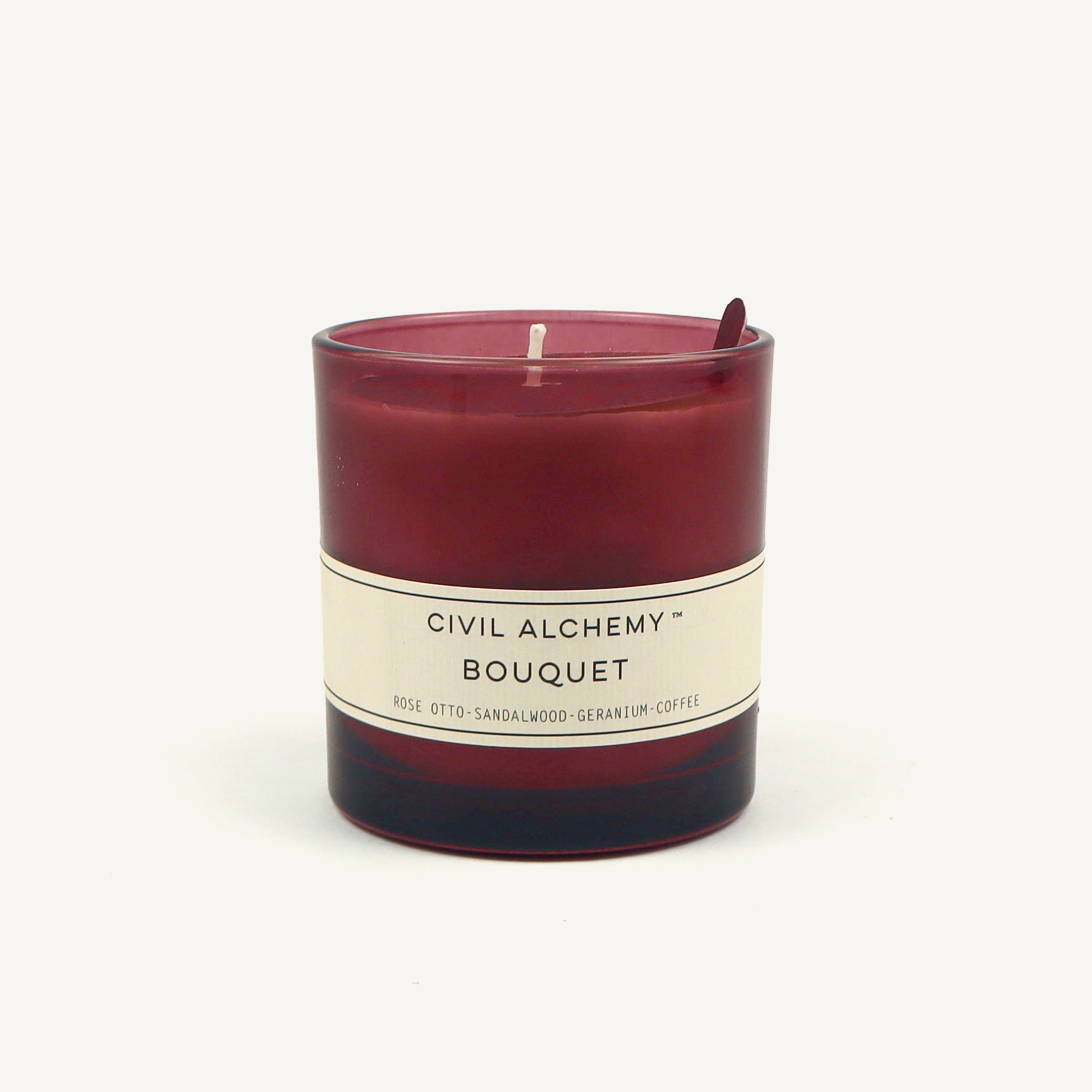 Red candle with a white label on a white background