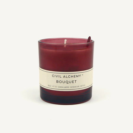 Red candle with a white label on a white background