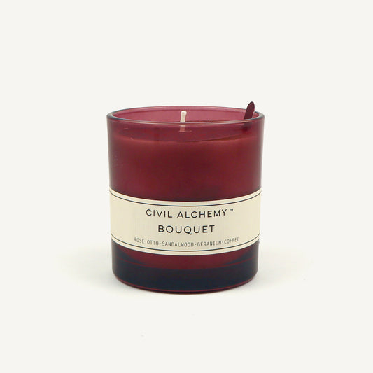 Red candle with a white label on a white background