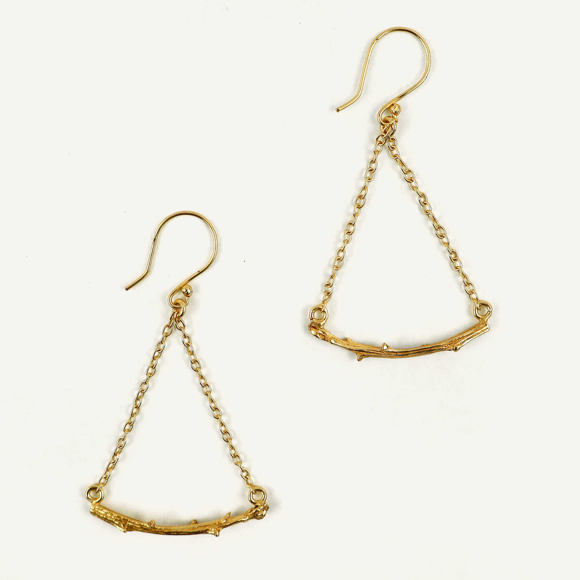 Gold chain earrings on a white background
