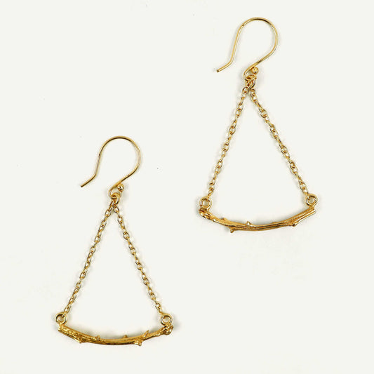 Gold chain earrings on a white background