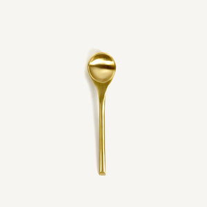 Gold spoon on a white background