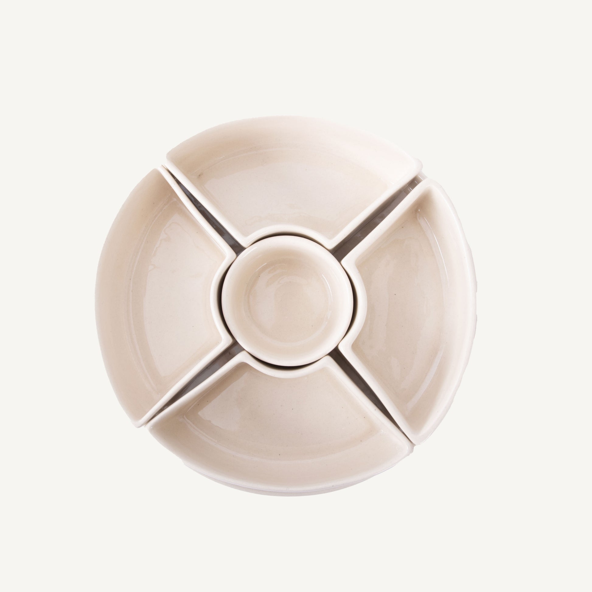 A beige ceramic sectioned dip platter with five compartments, arranged in a circular pattern.