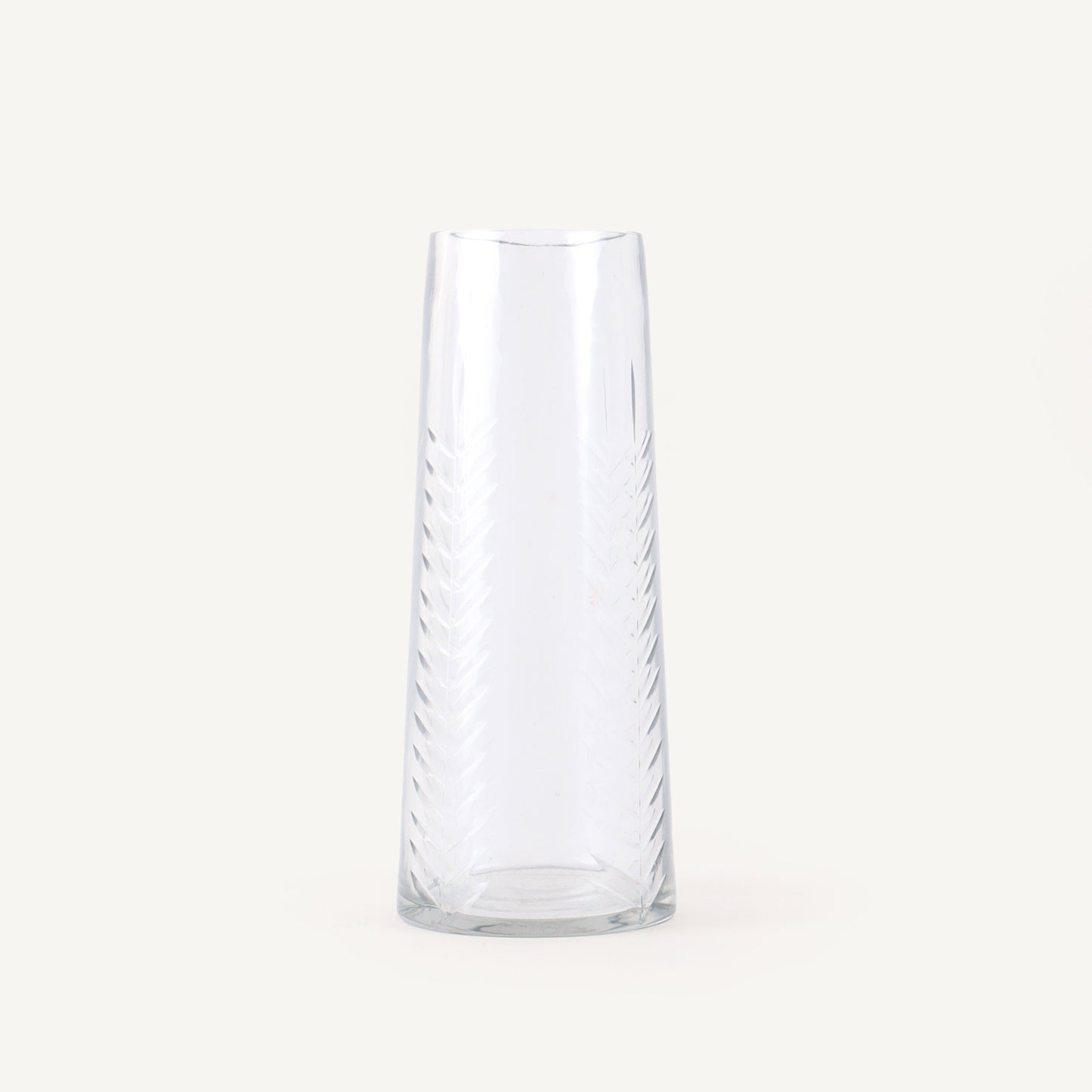 Clear glass vase with wavy design on a white background
