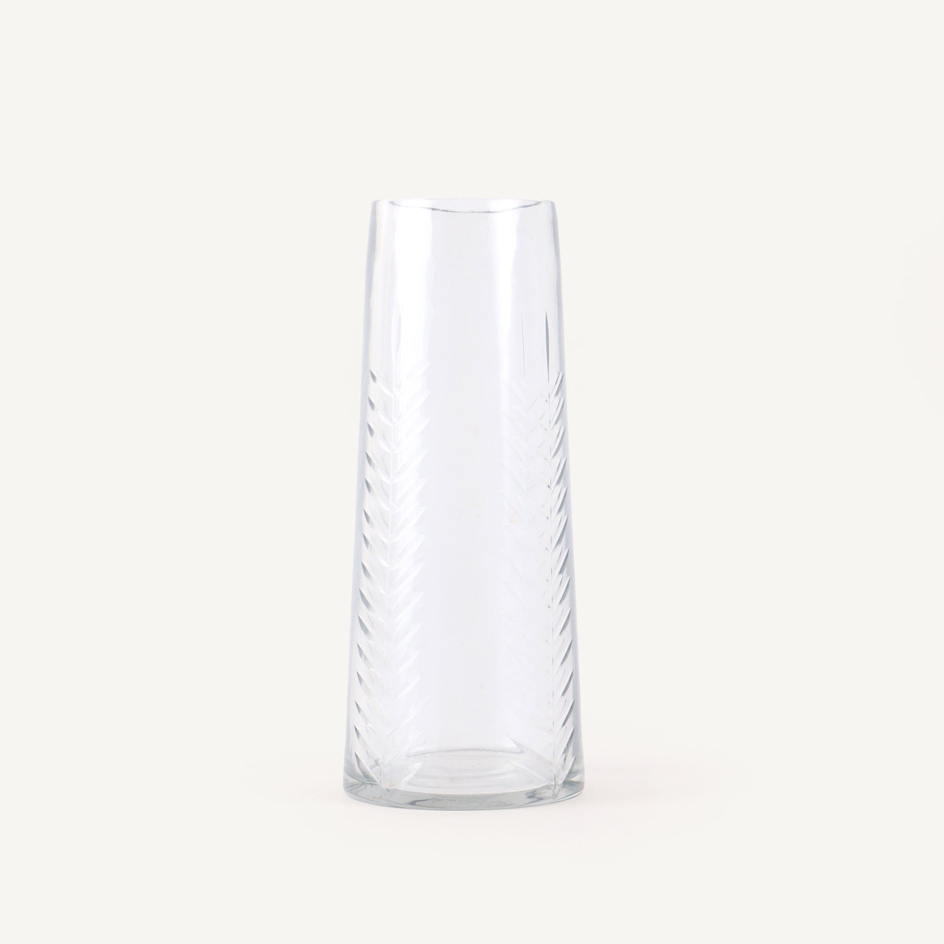 Clear glass vase with wavy design on a white background
