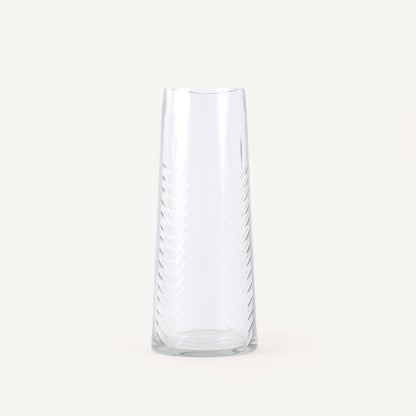 Clear glass vase with wavy design on a white background