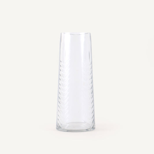 Clear glass vase with wavy design on a white background