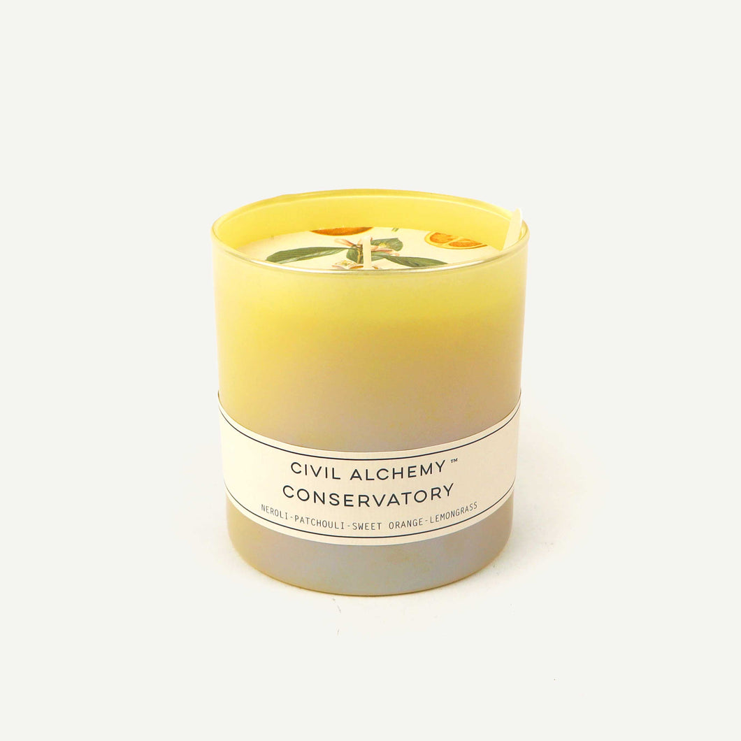 Yellow candle with a label on a white background