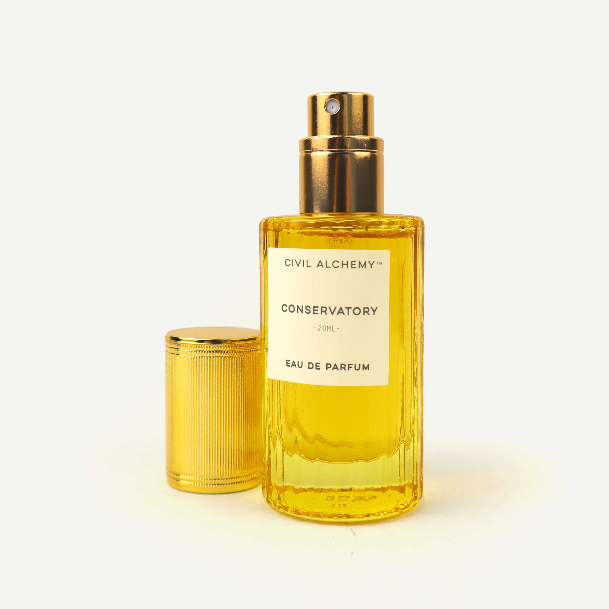 Yellow perfume bottle with gold cap on a white background