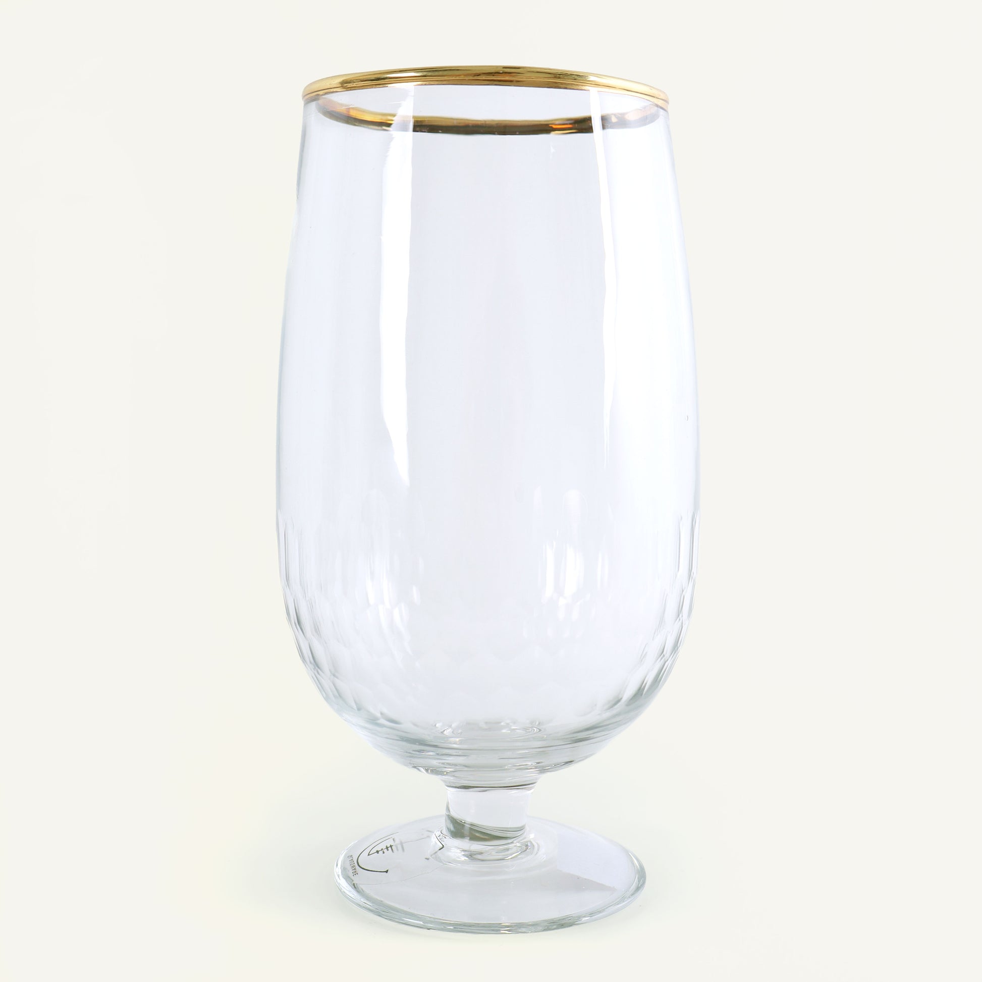 Clear glass with a gold rim on a white background