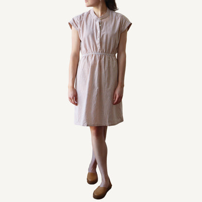 Woman wearing a checkered dress on a white background
