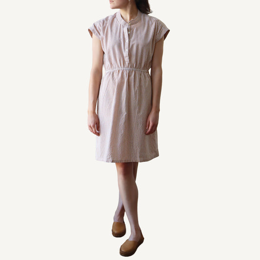 Woman wearing a checkered dress on a white background